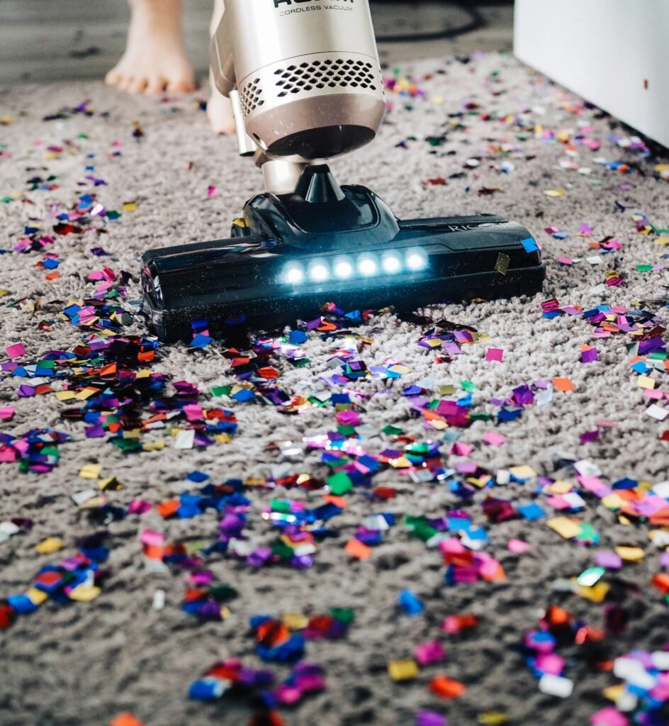 a person using a vacuum to clean a carpet